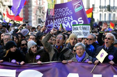 Demonstrators shout slogans as they hold flags, placards and a banner during the "March for Change" planned by left-wing party Podemos that emerged out of the "Indignants" movement, in Madrid on January 31, 2015. Tens of thousands of people took to the streets in Madrid today in support of a call for change from new anti-austerity party Podemos, a week after Greece elected its ally Syriza. AFP PHOTO/ GERARD JULIEN        (Photo credit should read GERARD JULIEN/AFP/Getty Images)