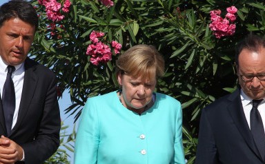 Italian Premier Matteo Renzi, left, German Chancellor Angela Merkel, center, and French President Francois Holland pay their homage at the tomb of Altiero Spinelli, one of the founding fathers of European unity, in the cemetery of the island of Ventotene, Italy, Monday, Aug. 22, 2016. Standing silently together, the three leaders placed three bouquets of blue and yellow flowers, the colors of the European Union, on the simple white marble tombstone of Altiero Spinelli in the cemetery of the island of Ventotene. (Carlo Hermann/Pool Photo via AP)
