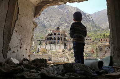 TOPSHOT - A photo taken on March 18, 2018, shows a Yemeni child looking out at buildings that were damaged in an air strike in the southern Yemeni city of Taez. / AFP PHOTO / Ahmad AL-BASHA        (Photo credit should read AHMAD AL-BASHA/AFP/Getty Images)