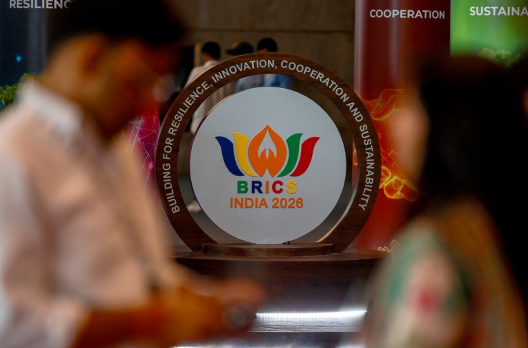 epa13236291 Media personnel stand near the BRICS signage at Bharat Mandapam, the venue for the BRICS Summit 2026, in New Delhi, India, 13 September 2026. India hosted the 18th BRICS Leaders' Summit from 12 to 13 September 2026 under the theme 'Building for Resilience, Innovation, Cooperation, and Sustainability.'  EPA/DIVYAKANT SOLANKI